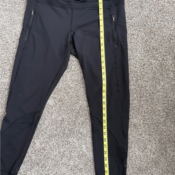 Lululemon black athletic pants with zippered pockets and a tapered silhouette - Picture 4 of 5